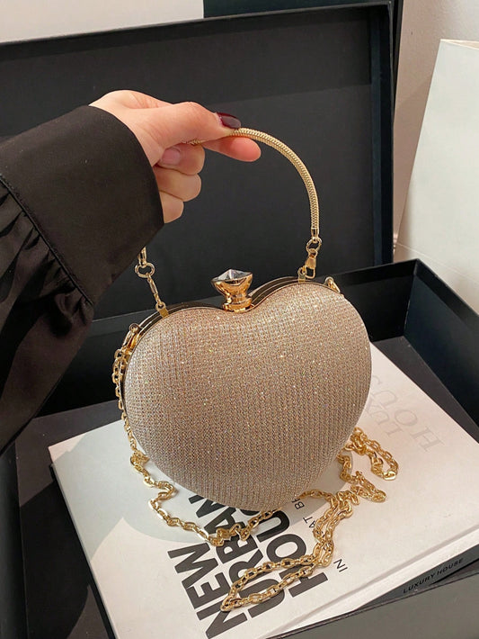 Amoré Clutch - Bolso rígido con forma de corazón y acabado brillante en champán
